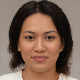 Joyful asian young-adult female with medium  brown hair and brown eyes