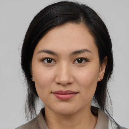 Joyful latino young-adult female with medium  brown hair and brown eyes