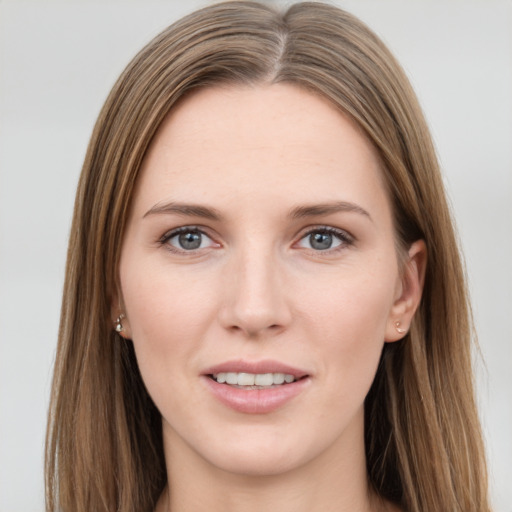 Joyful white young-adult female with long  brown hair and grey eyes