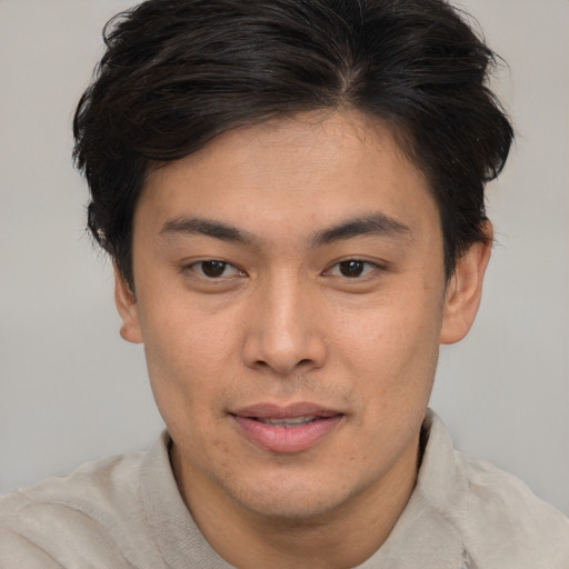 Joyful asian young-adult male with short  brown hair and brown eyes