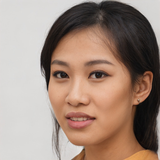 Joyful asian young-adult female with medium  brown hair and brown eyes