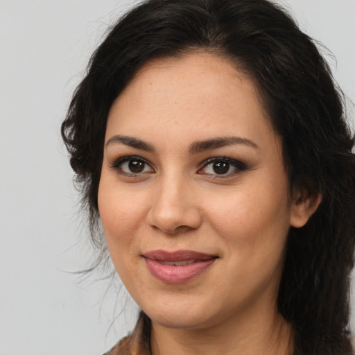 Joyful latino young-adult female with medium  brown hair and brown eyes