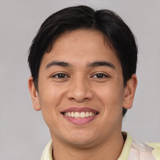 Joyful asian young-adult male with short  brown hair and brown eyes