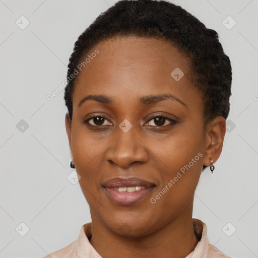 Joyful black young-adult female with short  black hair and brown eyes