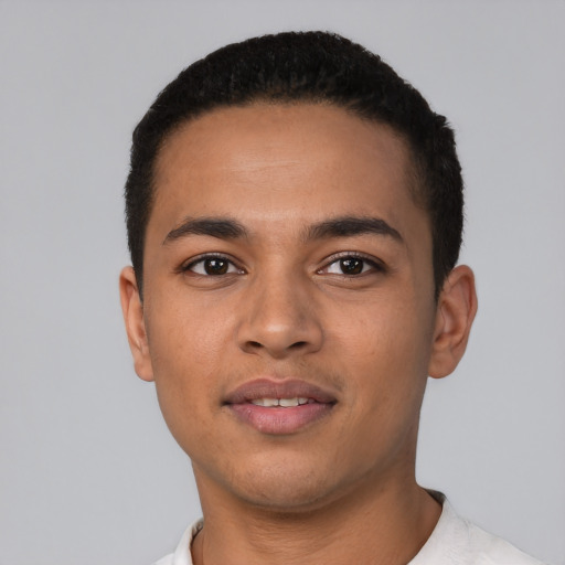 Joyful latino young-adult male with short  black hair and brown eyes