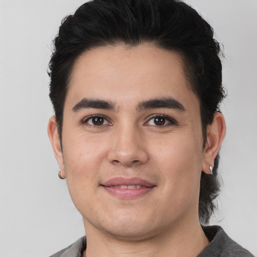 Joyful white young-adult male with short  black hair and brown eyes