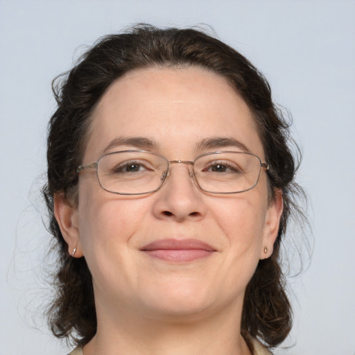 Joyful white adult female with medium  brown hair and green eyes