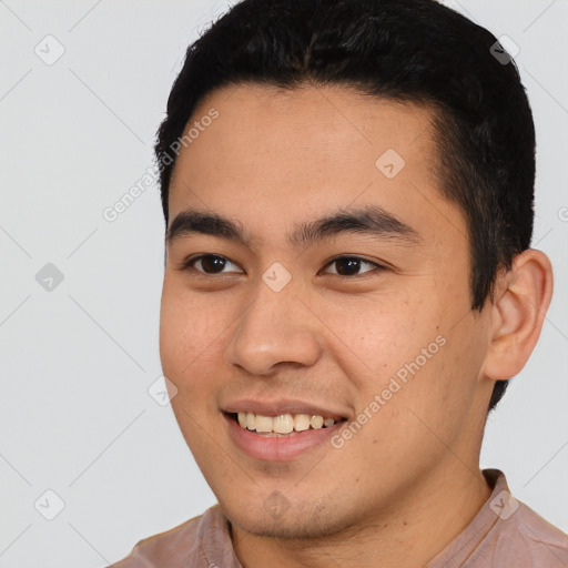 Joyful latino young-adult male with short  black hair and brown eyes