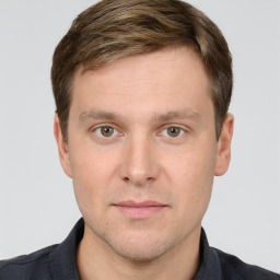 Joyful white young-adult male with short  brown hair and grey eyes