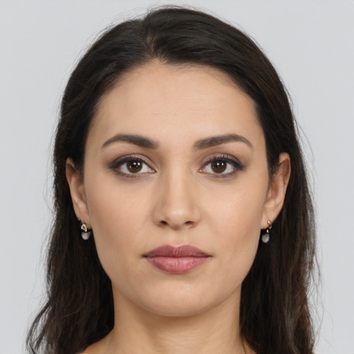 Joyful white young-adult female with long  brown hair and brown eyes