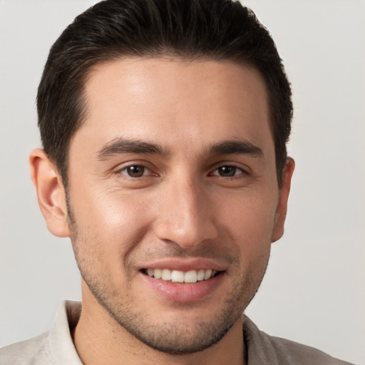 Joyful white young-adult male with short  brown hair and brown eyes