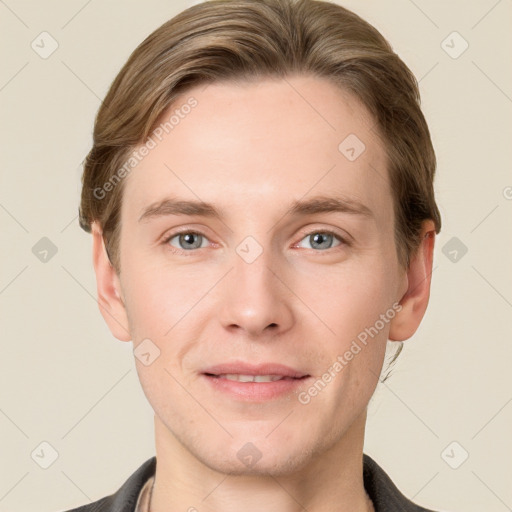 Joyful white young-adult male with short  brown hair and grey eyes