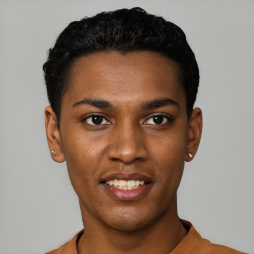 Joyful black young-adult male with short  black hair and brown eyes