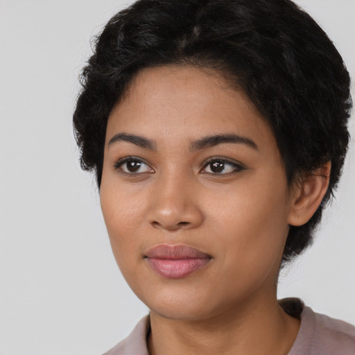 Joyful latino young-adult female with short  black hair and brown eyes