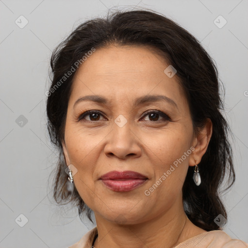 Joyful latino adult female with medium  brown hair and brown eyes