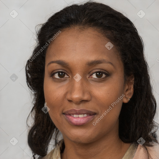 Joyful black young-adult female with long  brown hair and brown eyes