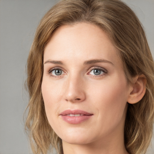 Joyful white young-adult female with medium  brown hair and blue eyes