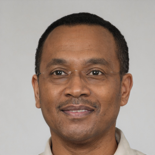 Joyful black adult male with short  black hair and brown eyes