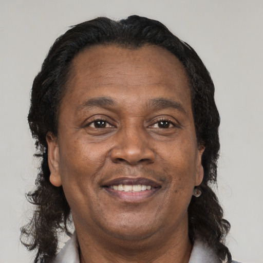 Joyful latino adult male with medium  brown hair and brown eyes