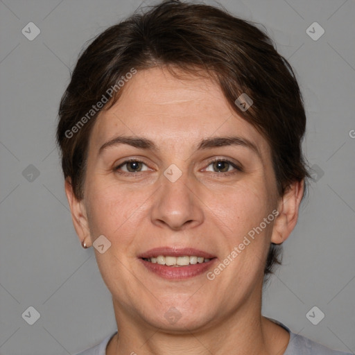 Joyful white adult female with short  brown hair and brown eyes