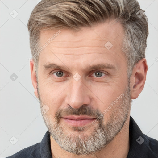 Joyful white adult male with short  brown hair and grey eyes