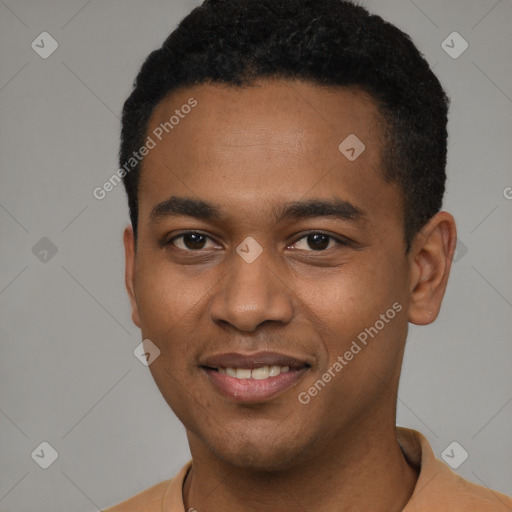 Joyful black young-adult male with short  black hair and brown eyes