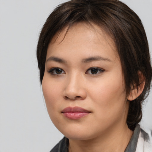 Neutral asian young-adult female with medium  brown hair and brown eyes