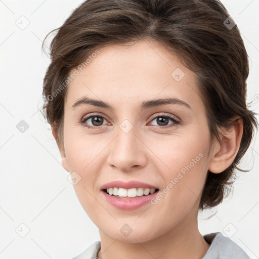 Joyful white young-adult female with medium  brown hair and grey eyes