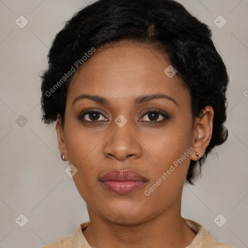 Joyful black young-adult female with short  black hair and brown eyes