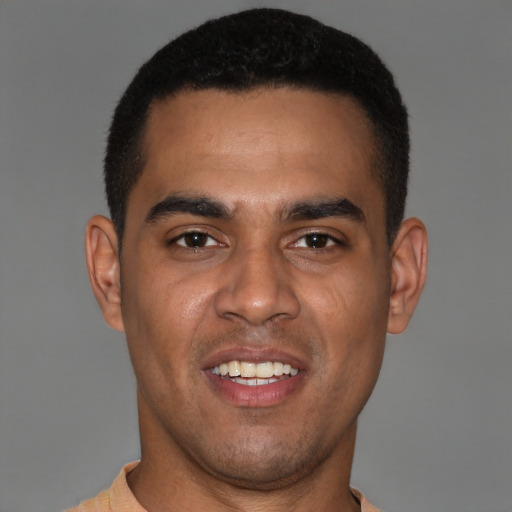 Joyful black young-adult male with short  black hair and brown eyes