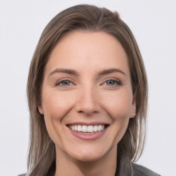 Joyful white young-adult female with medium  brown hair and grey eyes