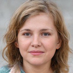 Joyful white young-adult female with medium  brown hair and blue eyes