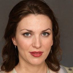 Joyful white young-adult female with medium  brown hair and blue eyes