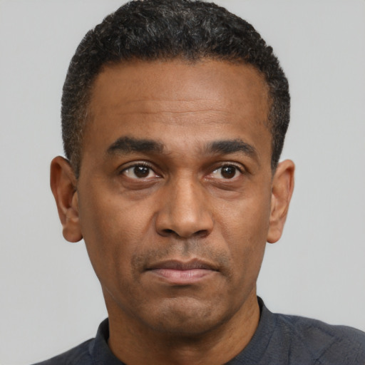 Neutral latino adult male with short  black hair and brown eyes