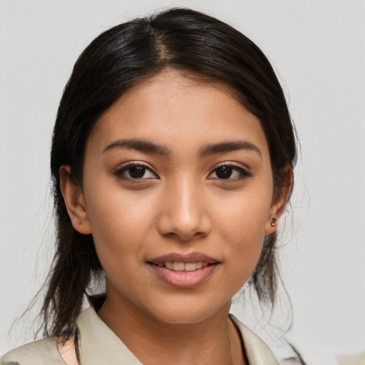 Joyful latino young-adult female with medium  brown hair and brown eyes