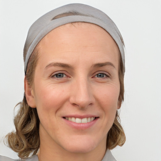 Joyful white young-adult female with medium  brown hair and blue eyes