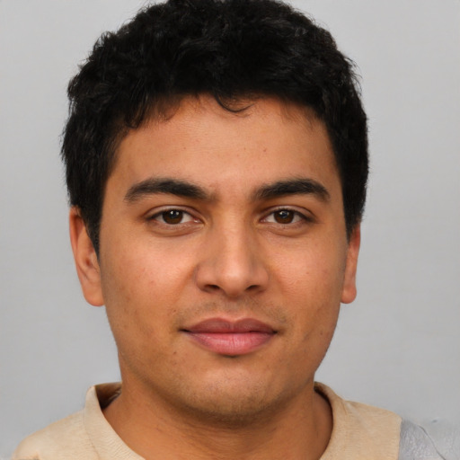 Joyful latino young-adult male with short  brown hair and brown eyes
