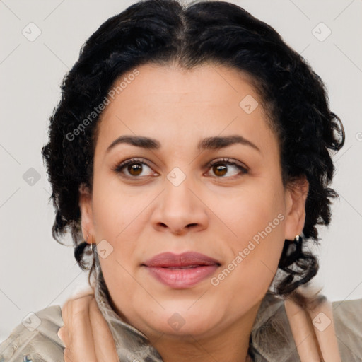 Joyful latino adult female with medium  brown hair and brown eyes