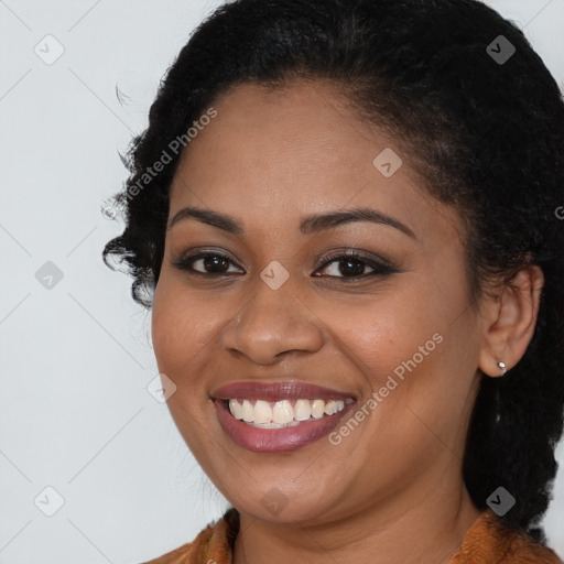 Joyful black young-adult female with long  brown hair and brown eyes