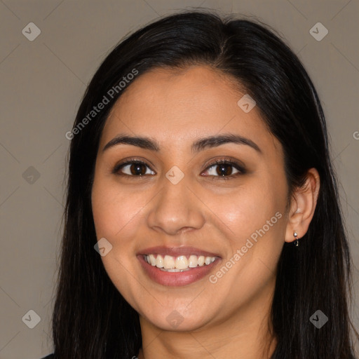 Joyful latino young-adult female with long  brown hair and brown eyes