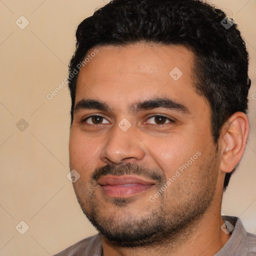 Joyful latino young-adult male with short  black hair and brown eyes