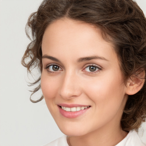 Joyful white young-adult female with medium  brown hair and green eyes