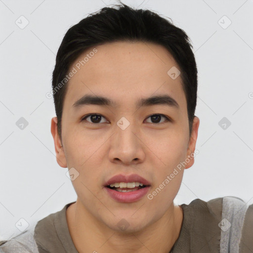 Joyful asian young-adult male with short  black hair and brown eyes