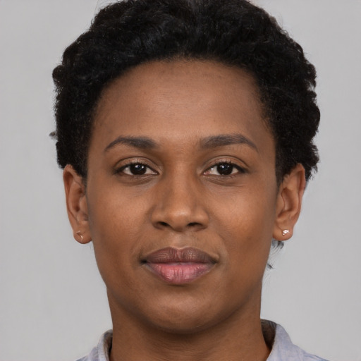Joyful black young-adult female with short  brown hair and brown eyes