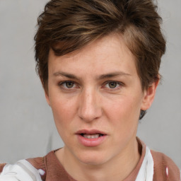 Joyful white adult female with short  brown hair and grey eyes