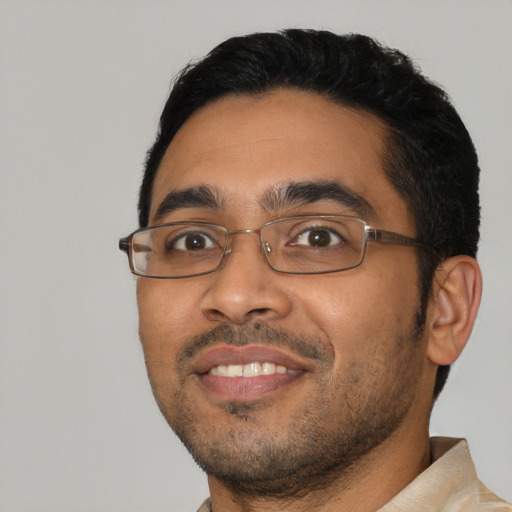 Joyful latino young-adult male with short  black hair and brown eyes