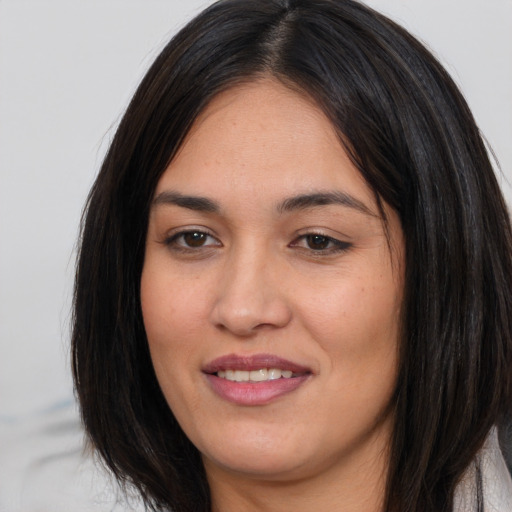 Joyful asian young-adult female with long  brown hair and brown eyes