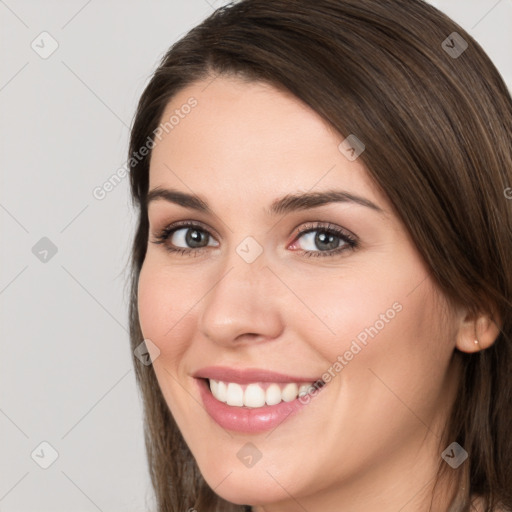 Joyful white young-adult female with long  brown hair and brown eyes