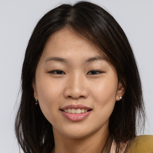Joyful asian young-adult female with long  brown hair and brown eyes