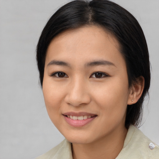 Joyful asian young-adult female with medium  brown hair and brown eyes